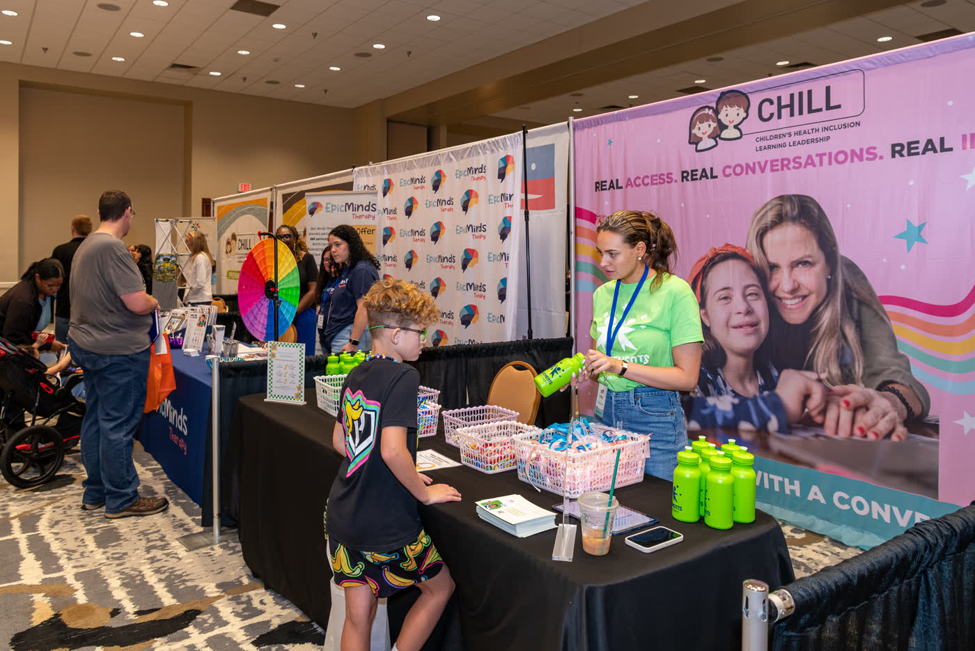 Families speaking with exhibitors at a CHILL ACT expo in Durham